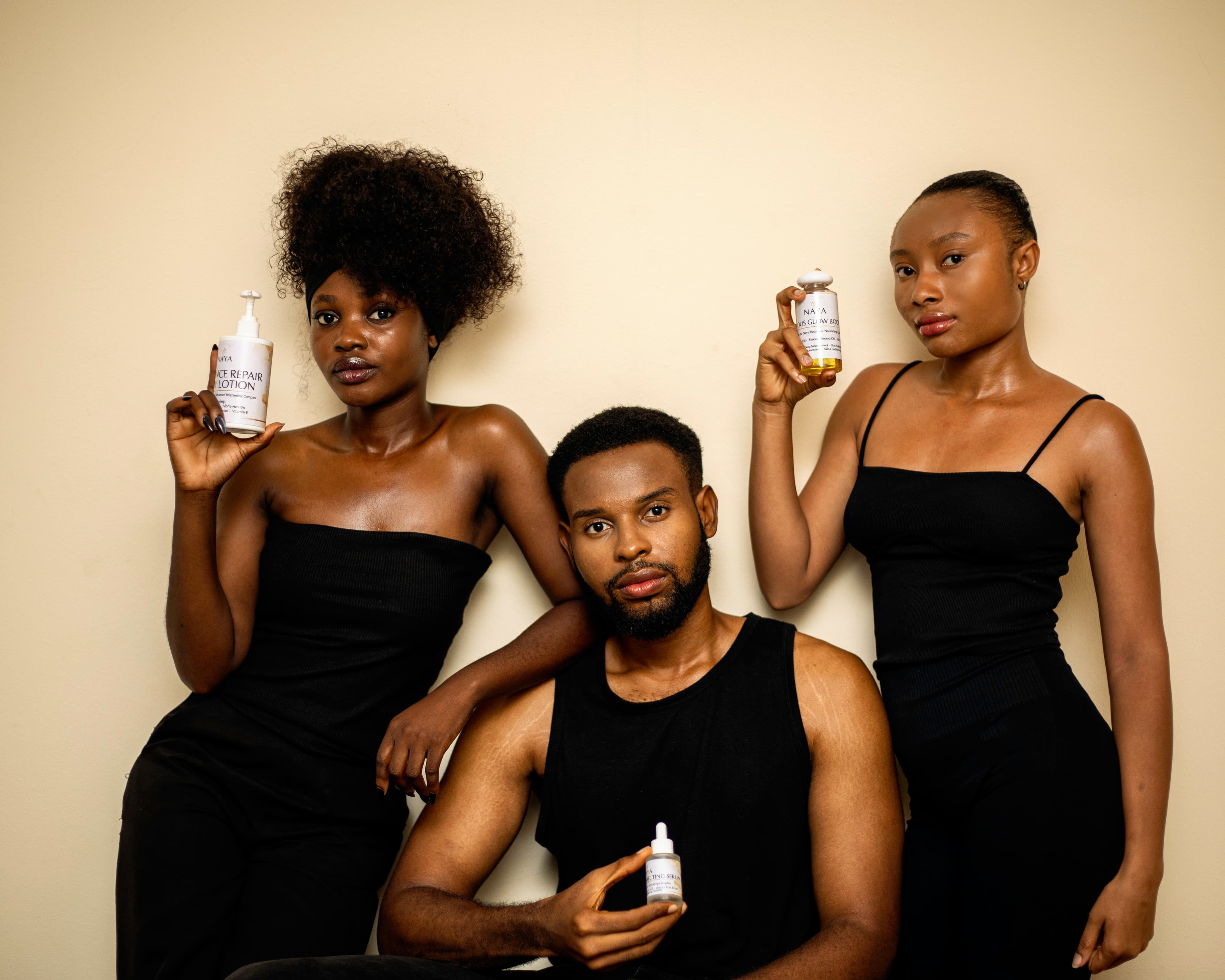 Naya Glows models holding Radiance Repair Lotion, Glow Body Oil, and Correcting Serum
